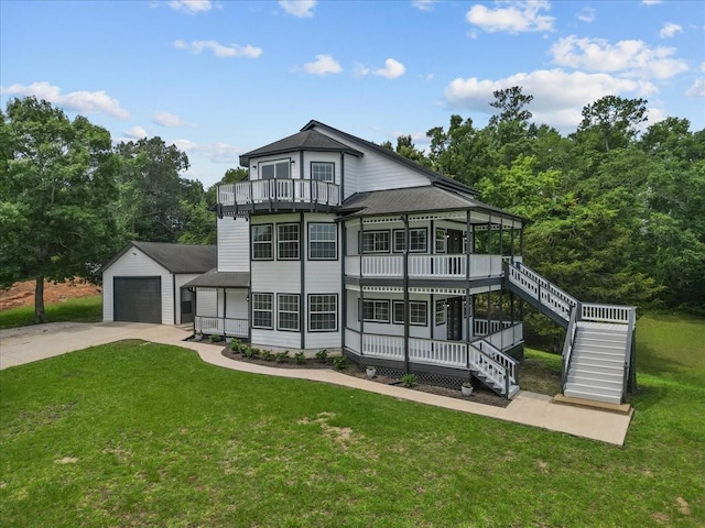 exterior space with a yard, stairway, a shingled roof, an outbuilding, and a balcony