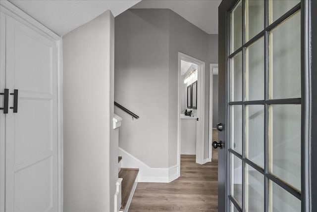 foyer featuring stairway, wood finished floors, and baseboards
