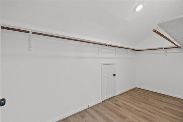 walk in closet with light wood-style flooring