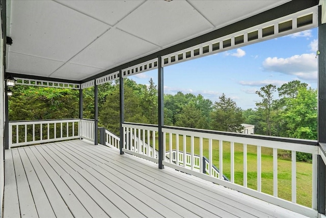 wooden deck with a lawn
