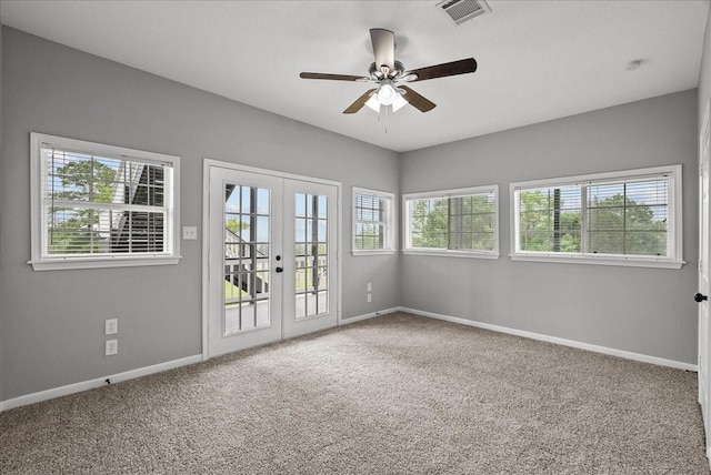 unfurnished room with visible vents, a ceiling fan, french doors, and carpet