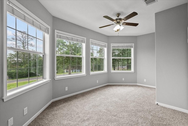 spare room featuring baseboards, visible vents, ceiling fan, and carpet flooring