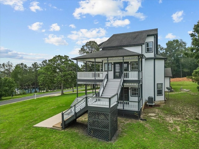 back of property featuring stairs, a deck, a shingled roof, central air condition unit, and a yard