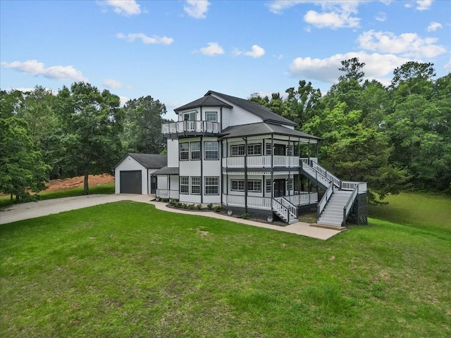 rear view of house with stairway, a balcony, an outdoor structure, covered porch, and a lawn