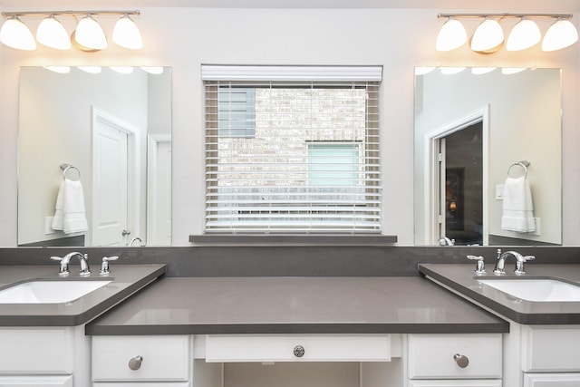 full bathroom with plenty of natural light and vanity