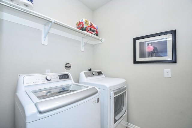 washroom featuring separate washer and dryer and laundry area