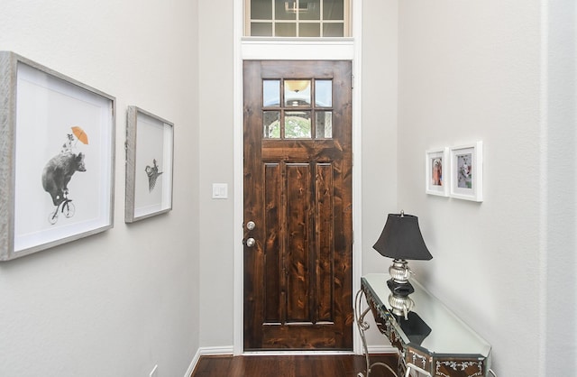 entryway featuring baseboards and wood finished floors