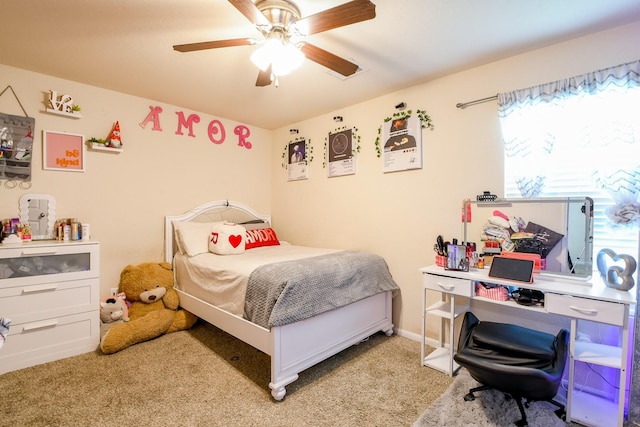bedroom with a ceiling fan and carpet