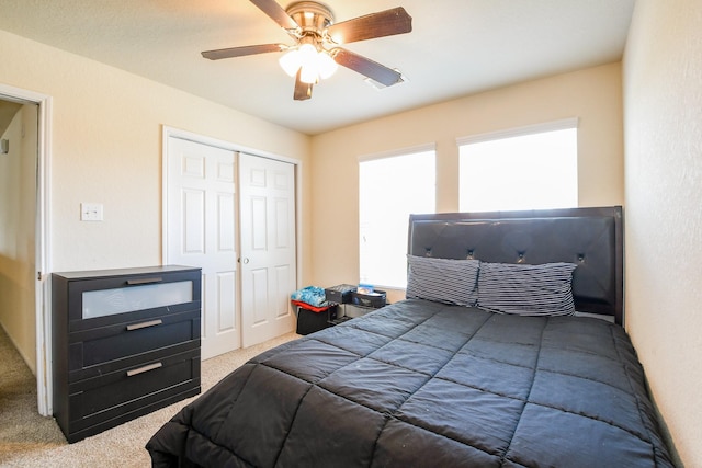 carpeted bedroom featuring visible vents, ceiling fan, and a closet