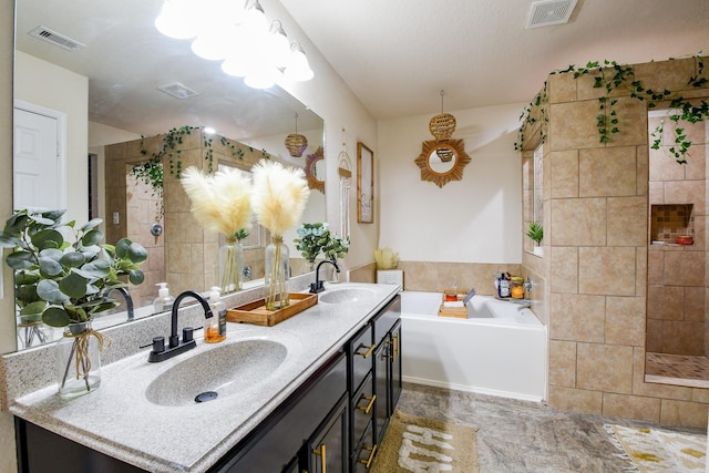 bathroom with visible vents, a stall shower, and a sink