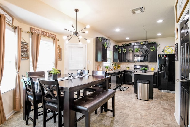 dining space featuring visible vents, recessed lighting, an inviting chandelier, and plenty of natural light