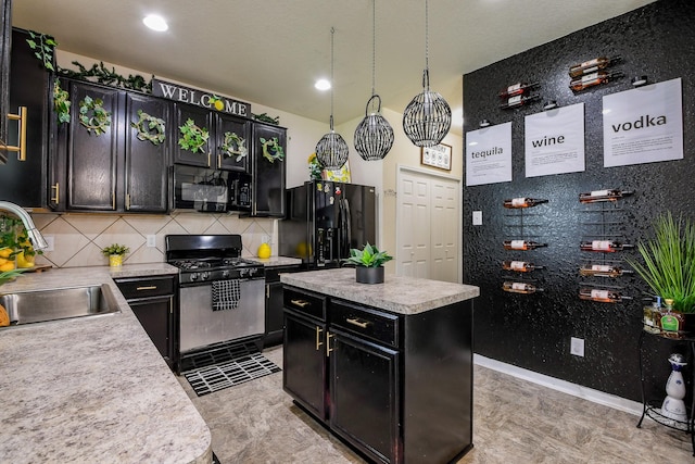kitchen featuring a sink, dark cabinetry, black appliances, backsplash, and light countertops