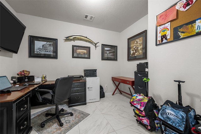 office space featuring visible vents, a textured ceiling, and marble finish floor