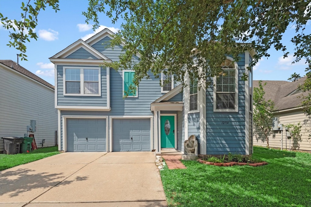 view of front facade featuring a garage, driveway, and a front yard