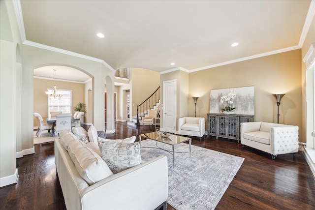 living area with a notable chandelier, arched walkways, stairs, wood finished floors, and ornamental molding