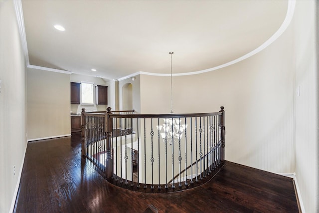 staircase with baseboards, ornamental molding, wood finished floors, and recessed lighting