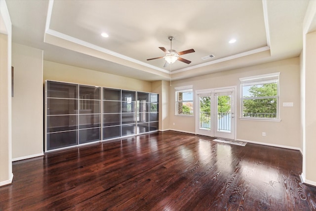 unfurnished room with crown molding, a tray ceiling, ceiling fan, and wood finished floors