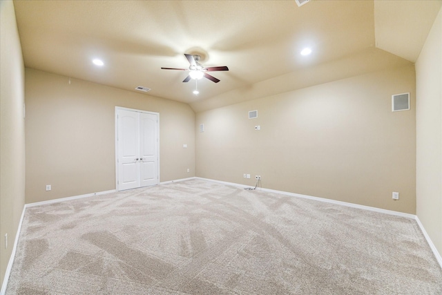 spare room with carpet floors, ceiling fan, baseboards, and visible vents