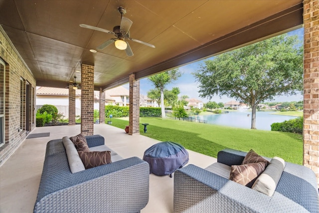 view of patio featuring a water view and ceiling fan
