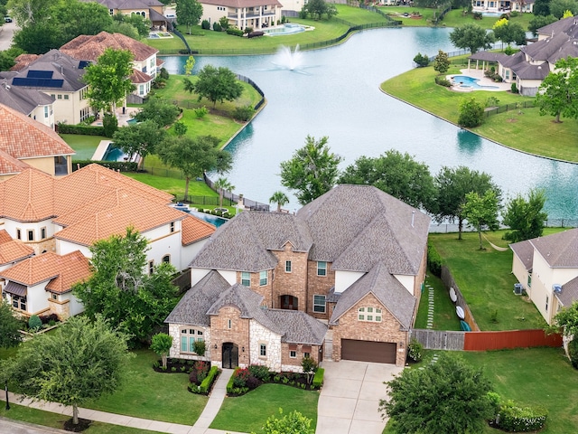 drone / aerial view with a water view and a residential view