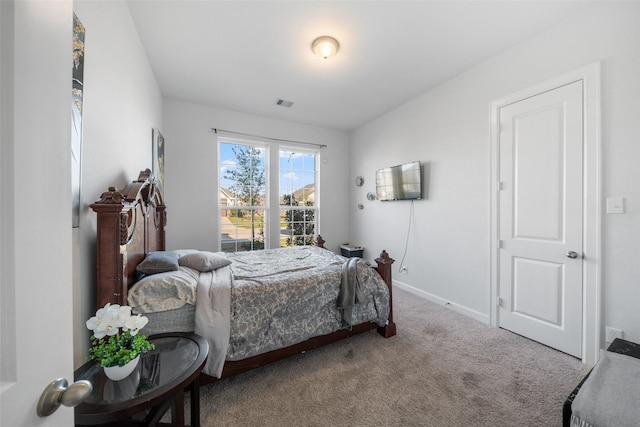 carpeted bedroom with baseboards and visible vents