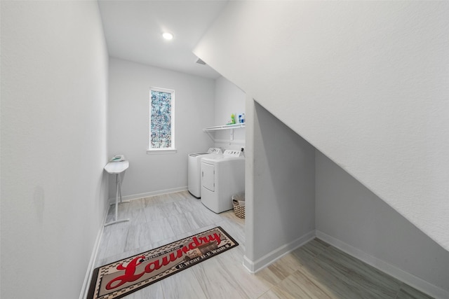 laundry room featuring washer and clothes dryer, baseboards, and laundry area