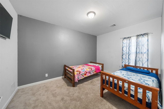 bedroom with baseboards, visible vents, and carpet flooring