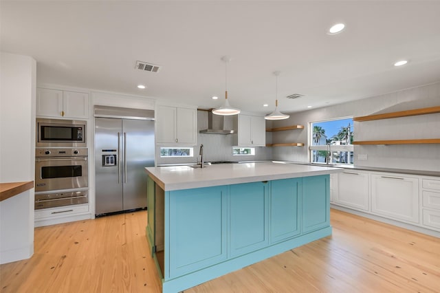 kitchen featuring open shelves, built in appliances, visible vents, a warming drawer, and wall chimney exhaust hood