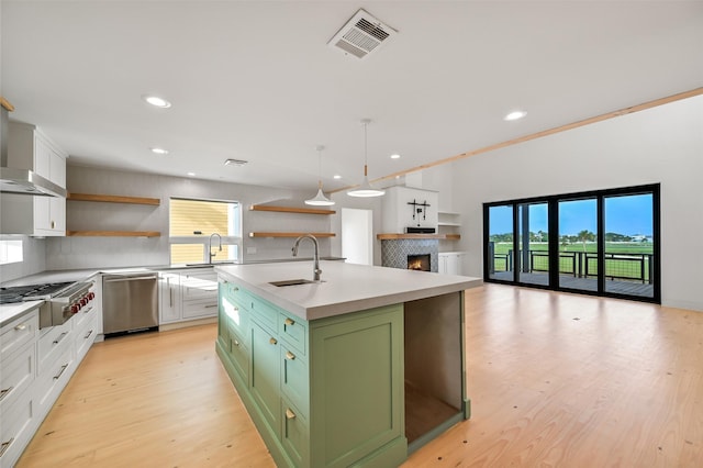 kitchen with green cabinetry, open shelves, visible vents, stainless steel appliances, and a healthy amount of sunlight