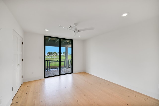spare room with recessed lighting, light wood-type flooring, ceiling fan, a wall of windows, and visible vents