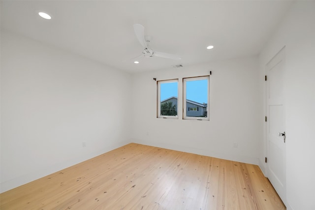 spare room with visible vents, recessed lighting, and wood-type flooring