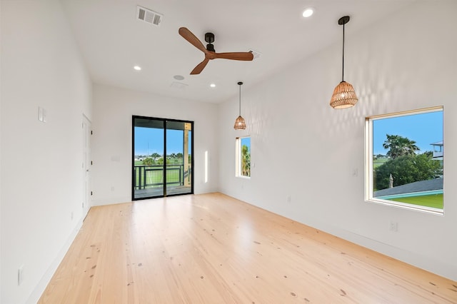 empty room with visible vents, a ceiling fan, light wood-style floors, and recessed lighting