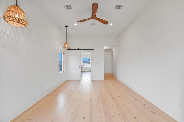 unfurnished living room featuring recessed lighting, light wood-style flooring, attic access, visible vents, and a ceiling fan