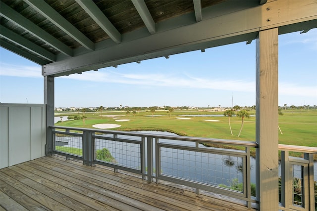 wooden deck with a water view and view of golf course