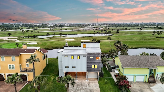 aerial view featuring golf course view and a water view