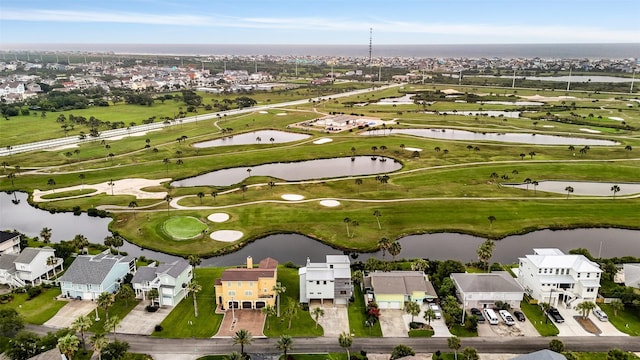 birds eye view of property with golf course view, a water view, and a residential view