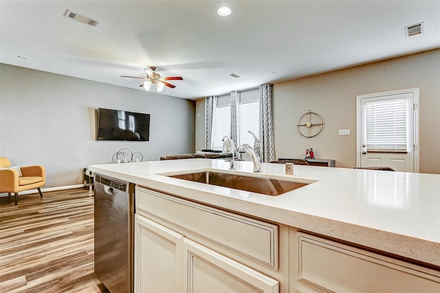 kitchen featuring stainless steel dishwasher, a ceiling fan, a sink, and visible vents