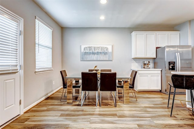 dining room featuring baseboards, recessed lighting, and light wood-style floors