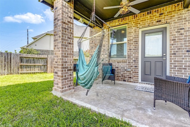 view of patio / terrace with fence and ceiling fan