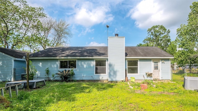 20983 Westgrove Ln, Porter, TX 77365 - back of property featuring a lawn, a chimney, and fence