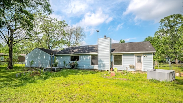 20983 Westgrove Ln, Porter, TX 77365 - back of property with a yard, a chimney, and fence