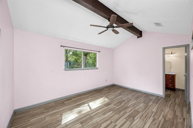 20983 Westgrove Ln, Porter, TX 77365 - unfurnished bedroom featuring visible vents, baseboards, wood finish floors, and vaulted ceiling with beams
