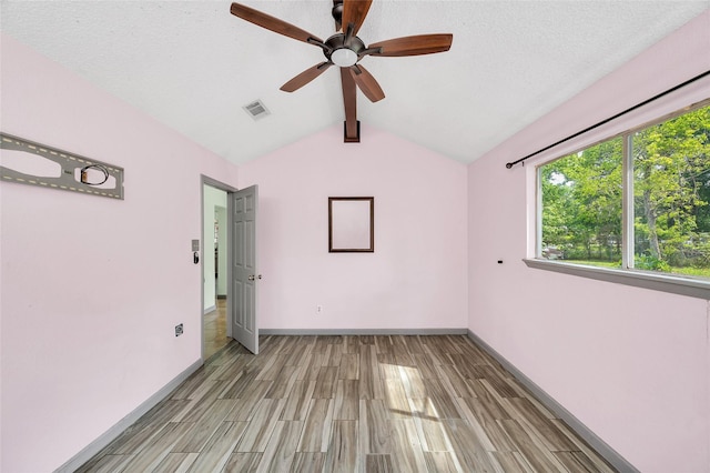 20983 Westgrove Ln, Porter, TX 77365 - spare room with baseboards, ceiling fan, visible vents, wood finish floors, and vaulted ceiling with beams