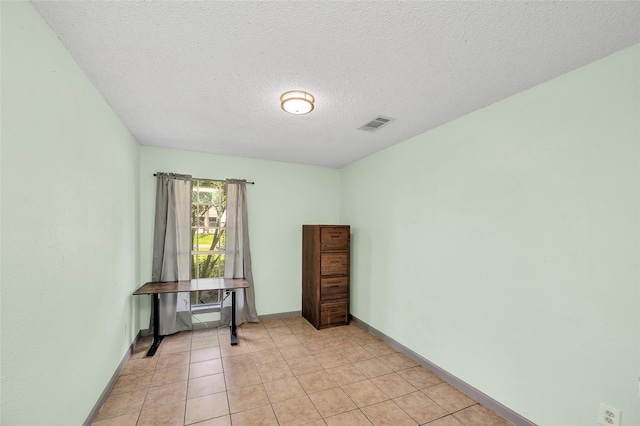 20983 Westgrove Ln, Porter, TX 77365 - spare room with a textured ceiling, visible vents, baseboards, and light tile patterned flooring