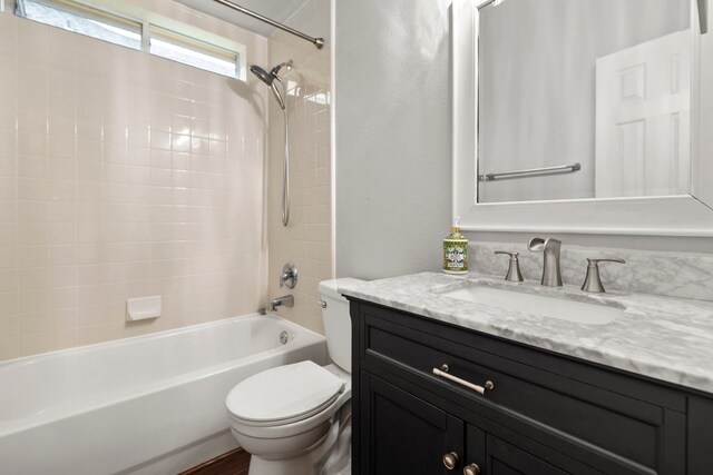 full bath featuring shower / bathtub combination, toilet, and vanity