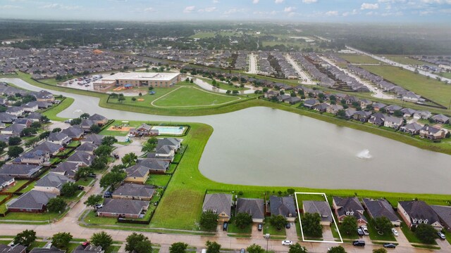 birds eye view of property featuring a water view and a residential view