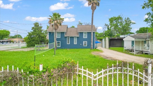 rear view of property featuring dirt driveway