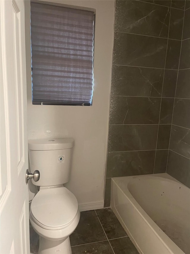 bathroom with tile patterned flooring, toilet, and baseboards