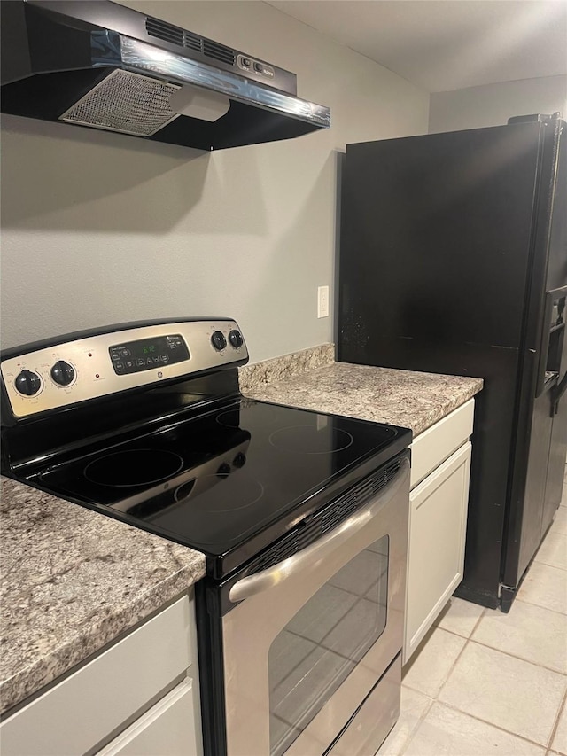 kitchen featuring stainless steel electric stove, under cabinet range hood, white cabinets, light tile patterned floors, and light countertops