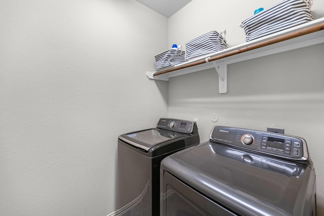 laundry area featuring washer and clothes dryer and laundry area